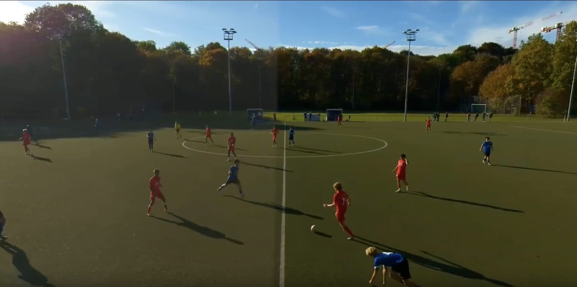 A match frame with the spotlight following the ball carrier