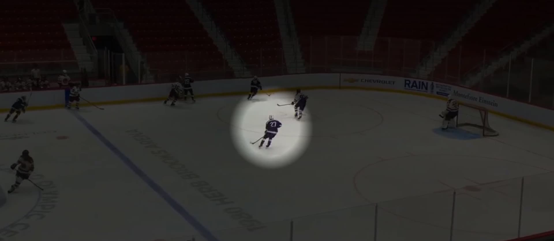 A spotlight isolating one skater as the play develops around him